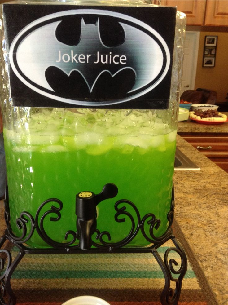 a green drink in a batman themed beverage dispenser