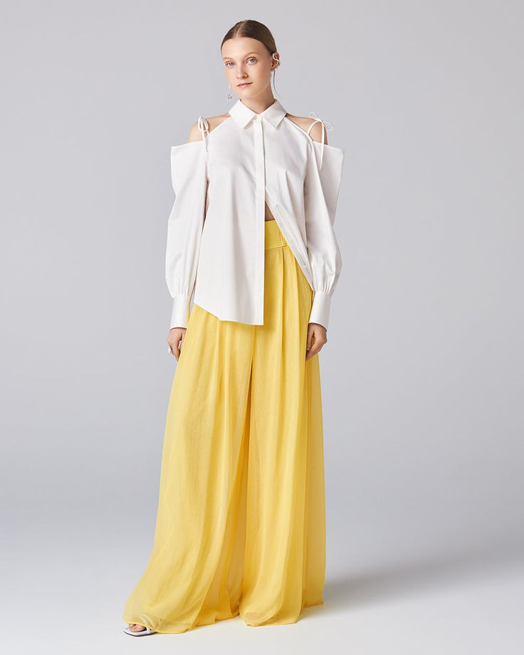 The Obi Shirt features cut-out shoulder details for a cold shoulder look. Rendered in classic cotton poplin fabric with a crisp finish and adorned with delicate shoulder ties. The oversized, masculine silhouette brings out ADEAM's signature chic and clean style. We recommend pairing it with Parade Pants. Designer Blouse With Spread Collar For Summer, Luxury White Cotton Blouse, Luxury Cotton Long Sleeve Blouse, Designer Summer Blouse In Relaxed Fit, Designer Summer Blouse With Relaxed Fit, Luxury Long Sleeve Cotton Blouse, Luxury Long Sleeve Tops For Spring, Luxury Cotton Shirt For Spring, Designer Formal Tops For Summer