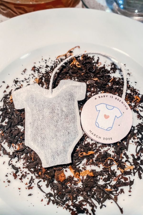 a white plate topped with a tea bag and some type of t - shirt on top of it