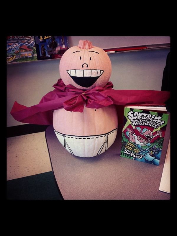 a pumpkin sitting on top of a table next to a box of gummy bears