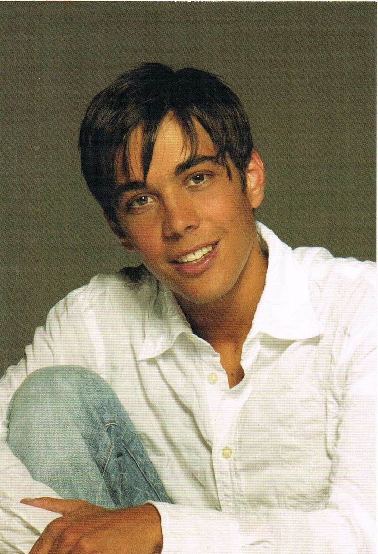 a young man is posing for a photo