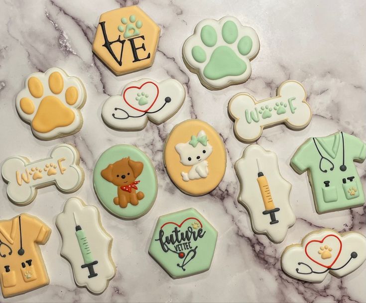 decorated cookies are arranged on a marble surface