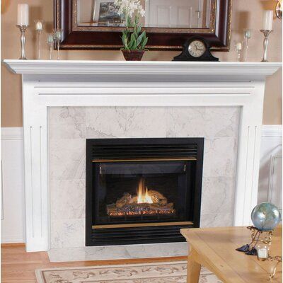 a living room with a fire place in the center and a rug on the floor