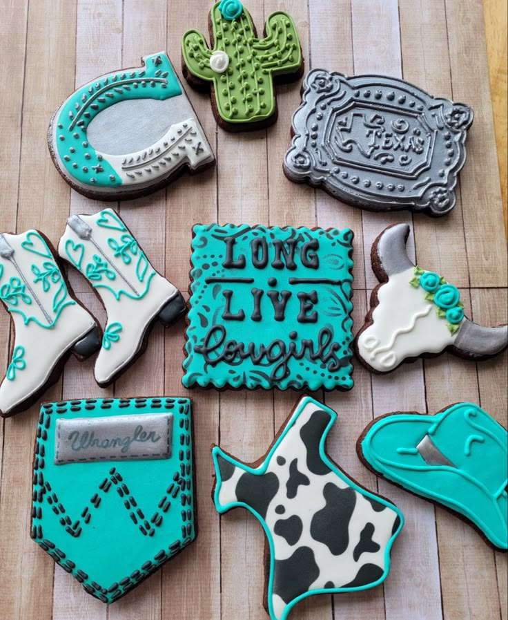 some decorated cookies are laying on a wooden table with the words long live texas written in it