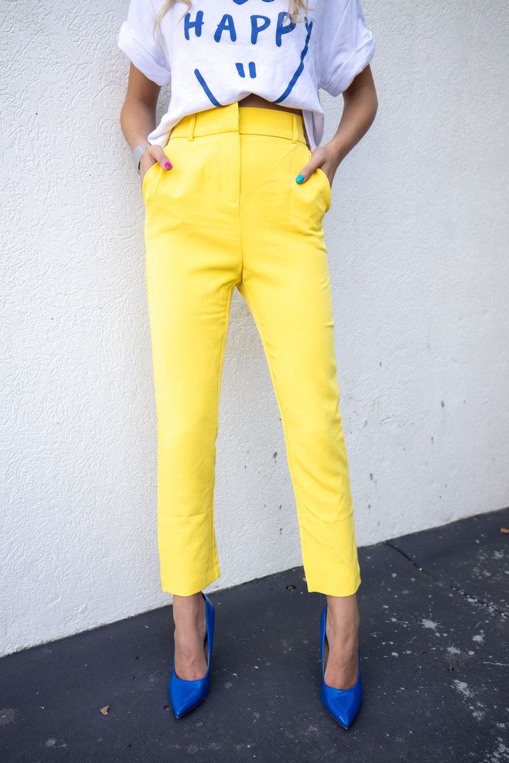 Seize the Day in our sunny yellow trouser pants. They have a removable belt buckle and a ankle crop. Seen paired with the Be Happy Tee and the Royal Blue heels. The best part? They have pockets! True to size. Model is 5'7 wearing size small. Kristin is 5'9 wearing size large and she typically wears a large. 97%Polyester 3% Spandex Seen styled with: Flower Power Sweater https://www.aspynandivy.com/products/green-flower-sweater?_pos=2&_sid=0ac68ffa4&_ss=r *Everything Measured in Inches Waist: Leng Royal Blue Heels, Happy Tees, Rainbow Outfit, Yellow Pants, Seize The Day, Blue Heels, Sunny Yellow, Neutral Outfit, How To Pose