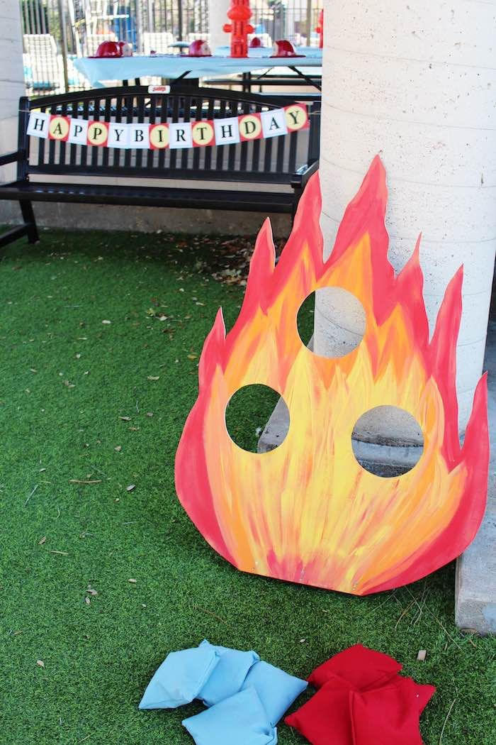 two pieces of paper sitting on the grass next to a fireman's mask