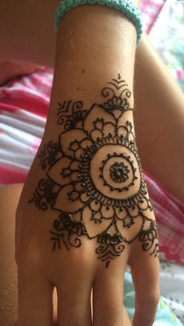 a woman's hand with henna on it