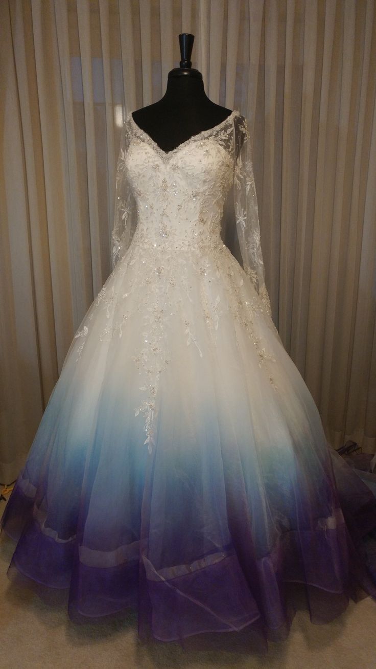 a white and blue wedding dress on a mannequin