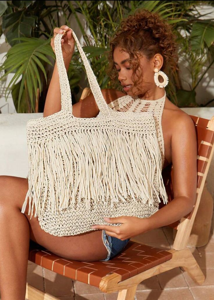 Expertly crafted with a woven design, this shoulder tote bag is both stylish and functional. The addition of fringe detailing adds a touch of elegance while providing extra storage space for your belongings. The versatile beige color makes it the perfect accessory for any outfit. Beige Bohemian Shoulder Bag For Shopping, Trendy Vacation Shoulder Bag With Fringe, Trendy Natural Bag With Fringe, Trendy Fringe Shoulder Bag For Vacation, Beige Crochet Bag With Tassels For Travel, Beige Woven Shoulder Bag For Shopping, Trendy Beige Shoulder Bag With Fringe, Casual Natural Bags With Fringe, Chic Beige Fringe Shoulder Bag