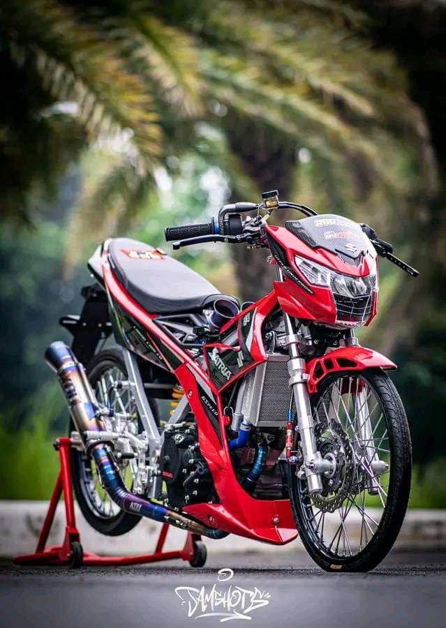 a red and black motorcycle parked on the street