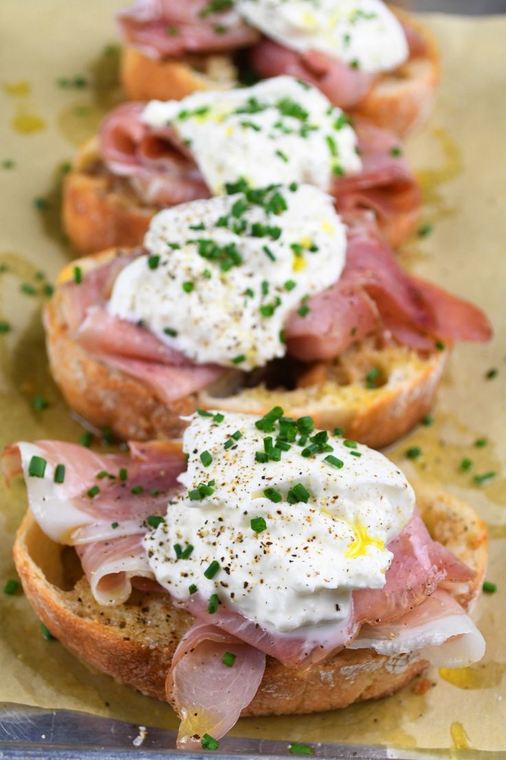 two open faced sandwiches topped with meat and sour cream on top of eachother