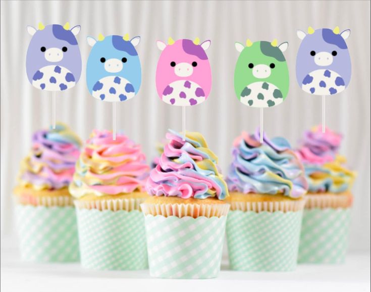 cupcakes with colorful frosting and animal decorations