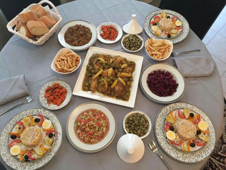 a table topped with plates and bowls filled with different types of food next to each other