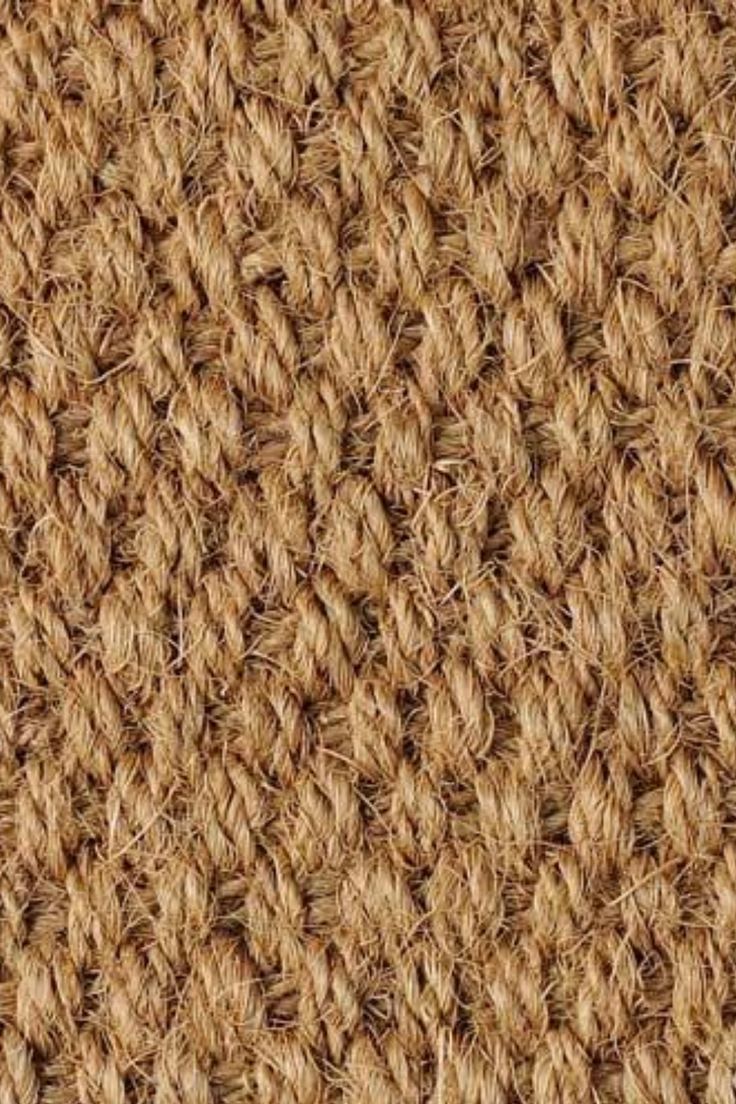 close up view of the texture of an area rug with brown and tan color scheme