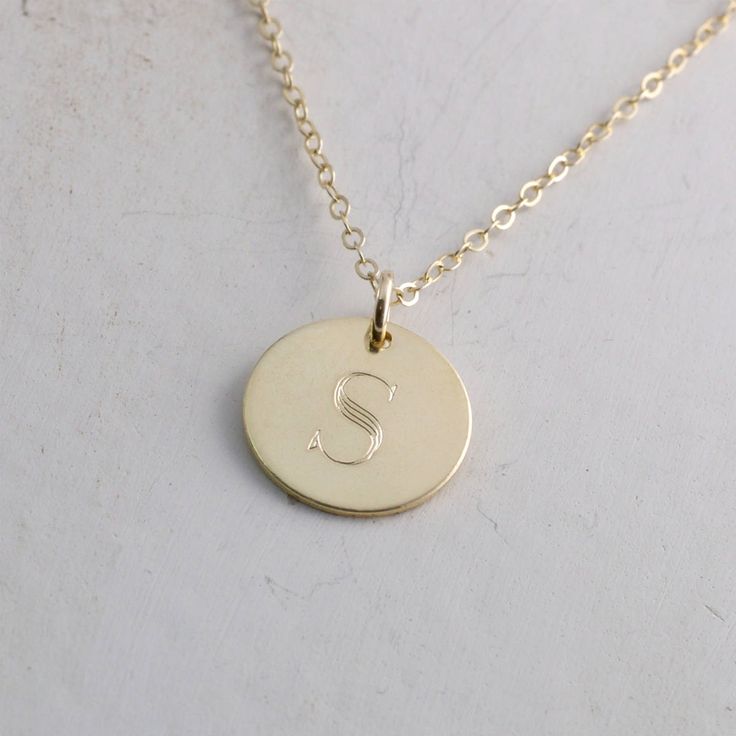 "Solid gold engraved initial necklace is a family heirloom that will be cherished and treasured for many years... it is the PERFECT gift! PICTURE IS ENLARGED TO SHOW DETAIL! SEE SECOND PICTURE FOR SIZE COMPARISON. PLEASE READ BELOW FOR ACTUAL MEASUREMENTS!! Your choice of one, two, or three solid gold 1/2\" (13mm) discs have been personalized just for you with a classy block font in a large 7mm size and it is GORGEOUS! (Font is shown in picture #6 above) The pendants hang from a solid 14k gold 1 Personalized Yellow Gold Necklaces For Anniversary, Personalized Yellow Gold Necklace For Anniversary, Formal Initials Nameplate Necklace, Formal Nameplate Initials Necklace, Personalized Heirloom Silver Necklace, Heirloom Personalized Silver Necklace, Heirloom Silver Personalized Necklace, Heirloom Style Personalized Necklace For Anniversary, Silver Nameplate Necklace Stamped 14k