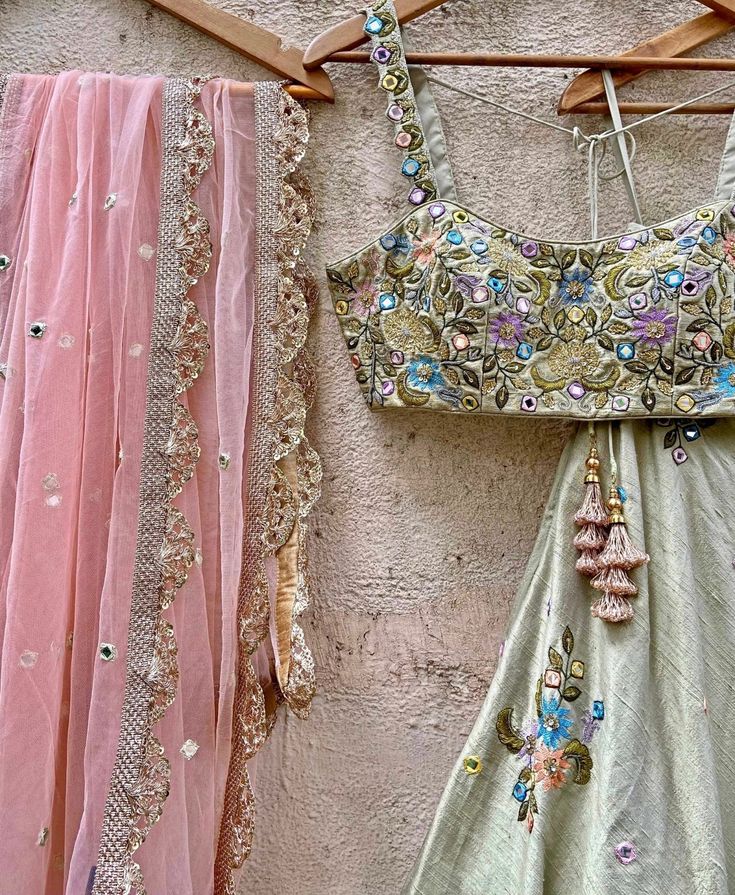 Features a tea Green raw silk lehenga with hand embroidered graceful swan and floral motifs in multi-hued thread work, beads, sequins and mirror detail. It is paired with an embroidered bustier and a soft net peach dupatta with mirror and thread work highlights. Composition : Lehenga and Blouse - Raw Silk, Dupatta - Soft Net All products can be customised for sleeves, length of blouse and neck design Delivery : 2-4 weeks as the product is hand crafted. Check Size Guide or choose MySize for free customisation (All Sizes above XL can be made at 15% additional cost) For more information and sizes please contact fabiliciousfashion@gmail.com or visit our Copenhagen studio.About the Designer : Priti Sahni started out with a career on the well-trodden path by following typical Indian parent’s goa Green Raw Silk Lehenga With Mirror Work, Green Tissue Silk Lehenga With Mirror Work, Pista Green Raw Silk Choli With Intricate Embroidery, Pista Green Dola Silk Choli With Mirror Work, Pista Green Chanderi Choli With Mirror Work, Party Wear Pista Green Dola Silk Choli, Green Tissue Silk Choli With Mirror Work, Bohemian Silk Lehenga With Mirror Work, Bohemian Dola Silk Choli For Wedding