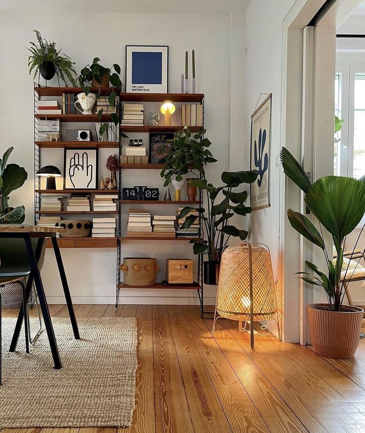 a living room filled with furniture and lots of plants