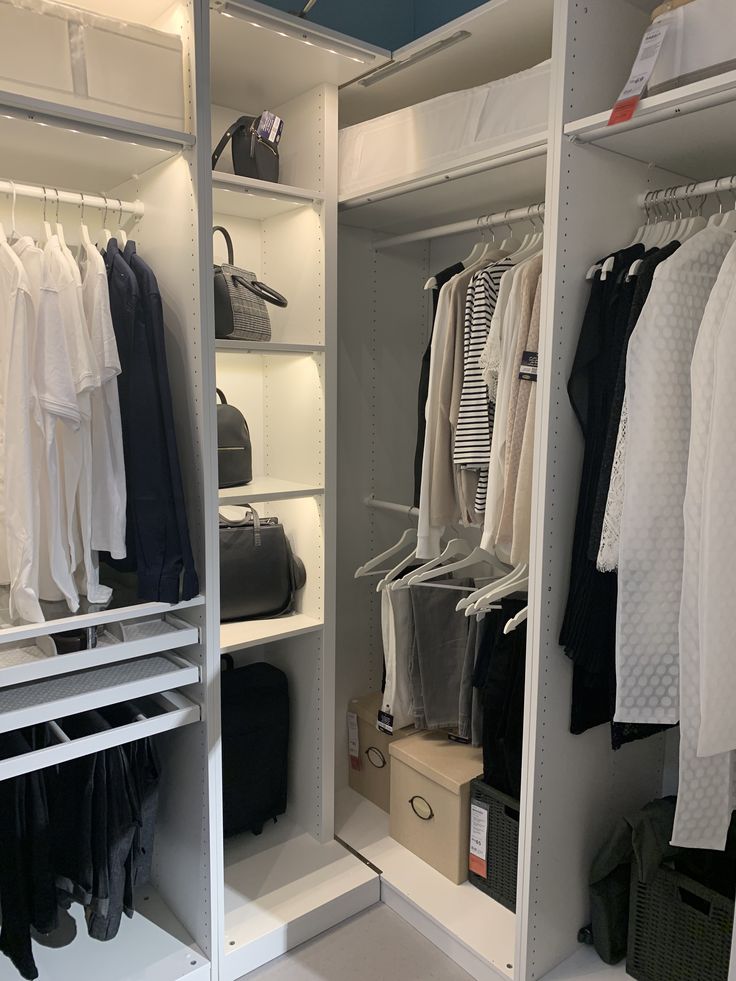 an organized closet with clothes and suitcases