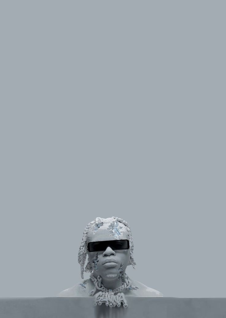 a woman wearing sunglasses and headdress in front of a gray background