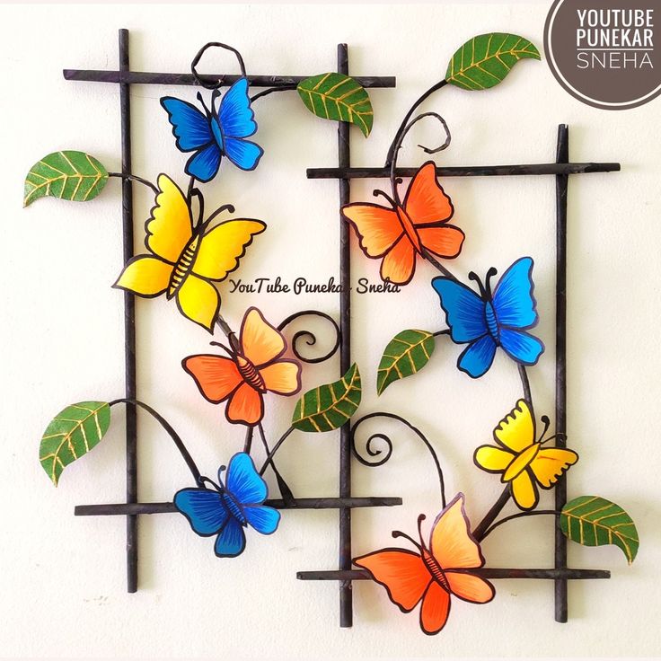 a metal wall sculpture with colorful butterflies on it