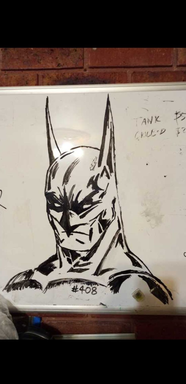 a batman drawing on a white board with writing