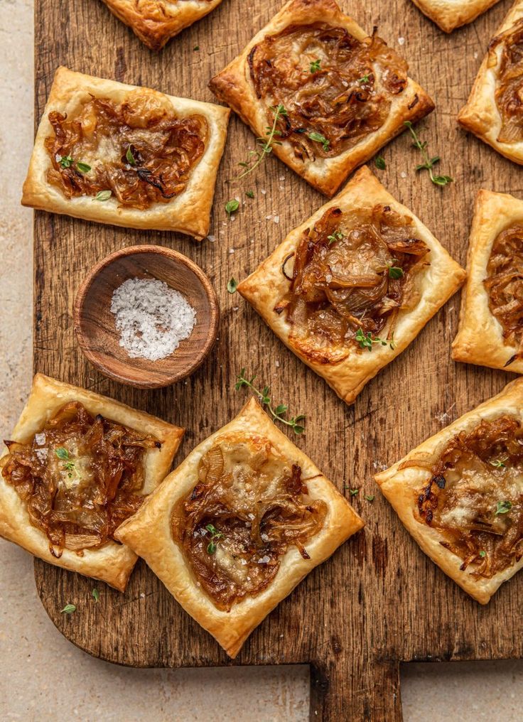 many small pieces of food on a wooden board