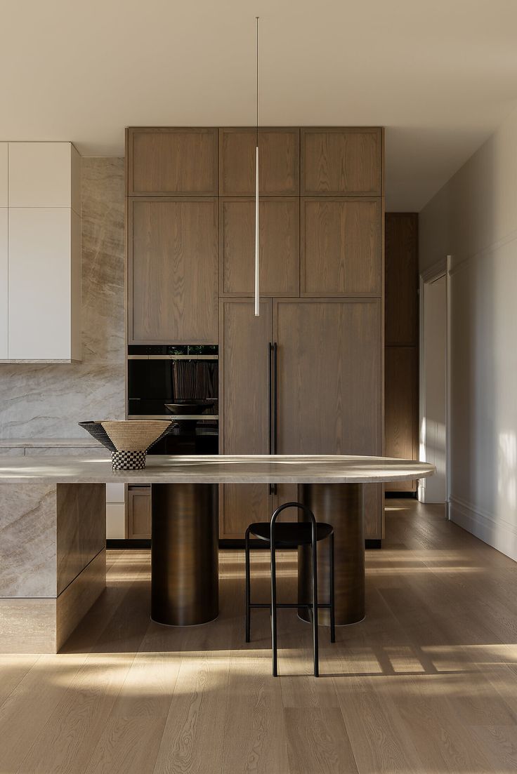 a modern kitchen with wooden cabinets and marble counter tops