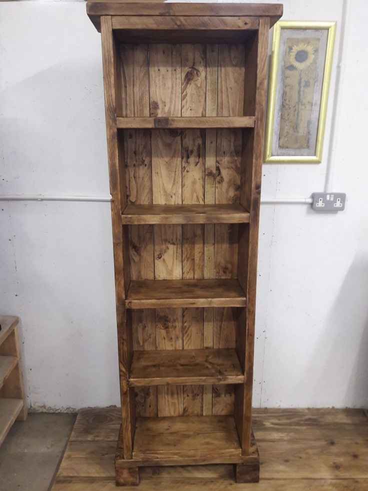 a wooden bookcase sitting on top of a hard wood floor