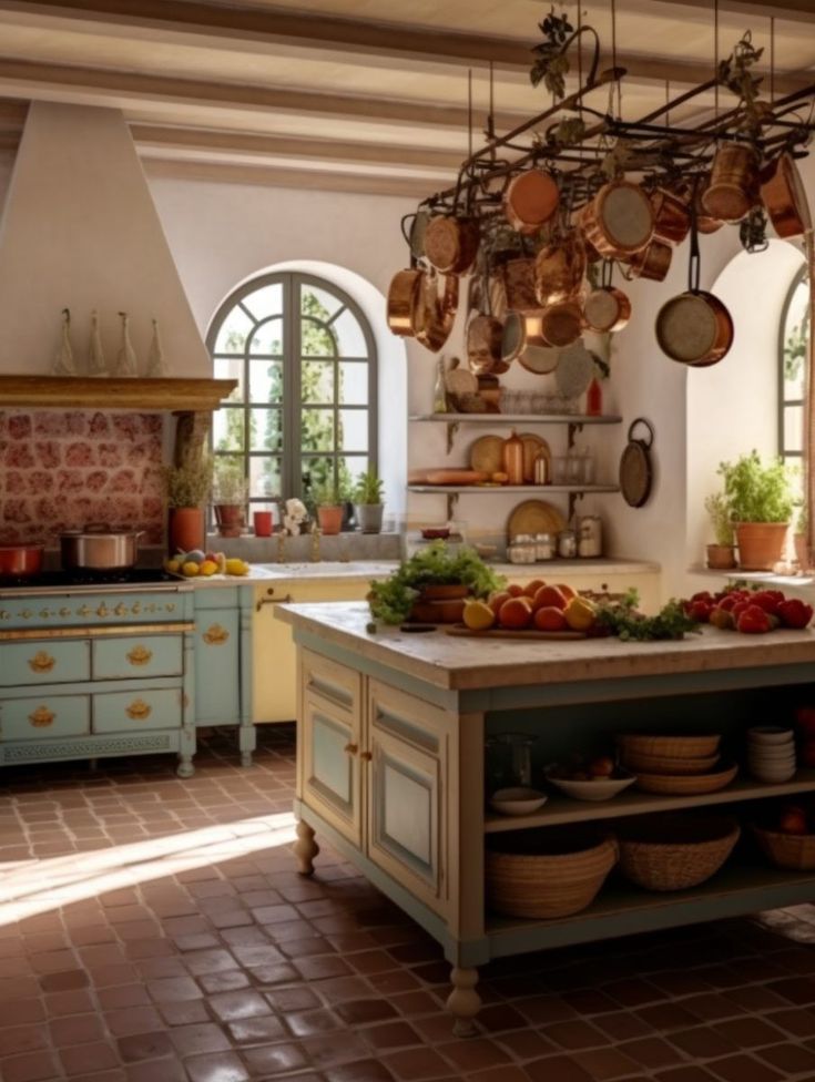 a large kitchen with many pots and pans hanging from the ceiling over the island