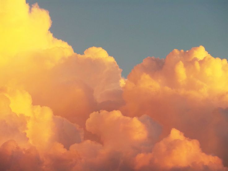 an airplane is flying through the clouds in the sky