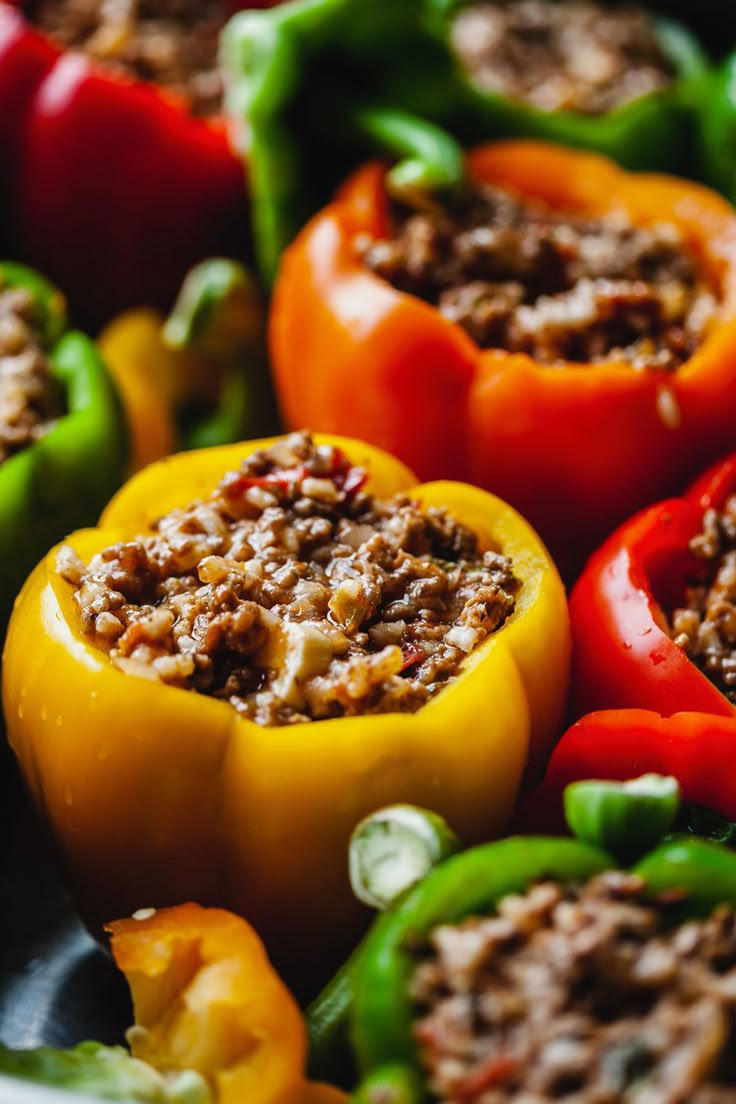 several peppers with meat in them sitting on a plate and ready to be cooked or eaten