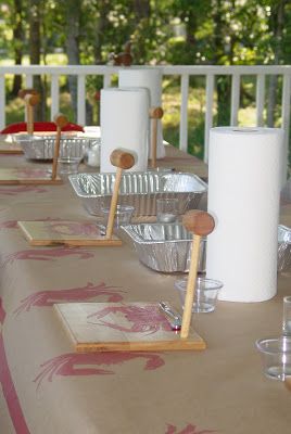 the table is set with glasses, plates and utensils for dinner on the deck