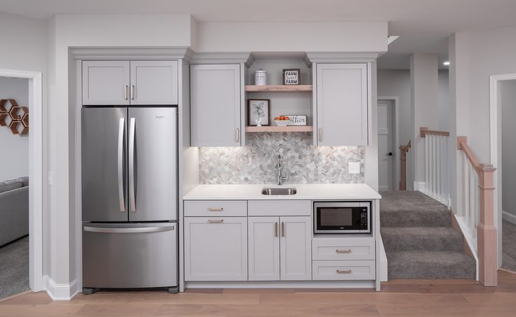 a kitchen with white cabinets and stainless steel appliances