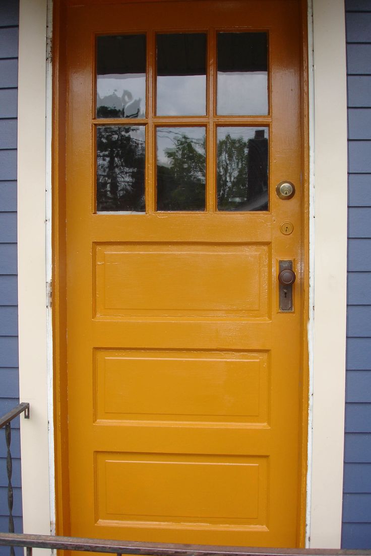 a yellow door with three panes on it