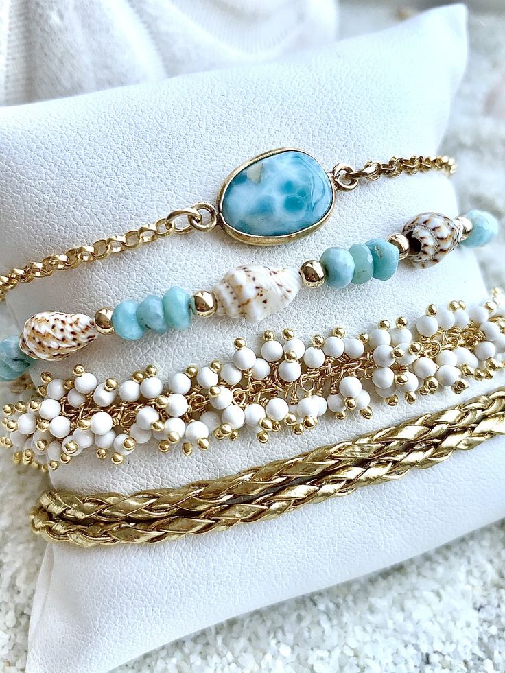 "Beautiful Ocean Lover Bracelet Set Including Larimar Ocean Goddess Chain Bracelet Larimar & Bahama sea shell Bracelet White Coral Bracelet Golden double leather wrap All bracelets are 14k gold over sterling silver 100 % ocean proof Floridian Ocean Jewelry \"Sea Lifes Beauty\"" Gold Strand Bracelet With Ocean-inspired Style, Elegant Stackable Beaded Bracelets For Beach, Elegant Stackable Beach Jewelry, Elegant Turquoise Bracelets For Beach, Elegant Gold Strand Jewelry, Beach Gold Hand Wrapped Jewelry, Gold Hand Wrapped Jewelry For The Beach, Ocean-inspired Gold Bracelets For Gifts, White Multi-strand Beach Bracelets