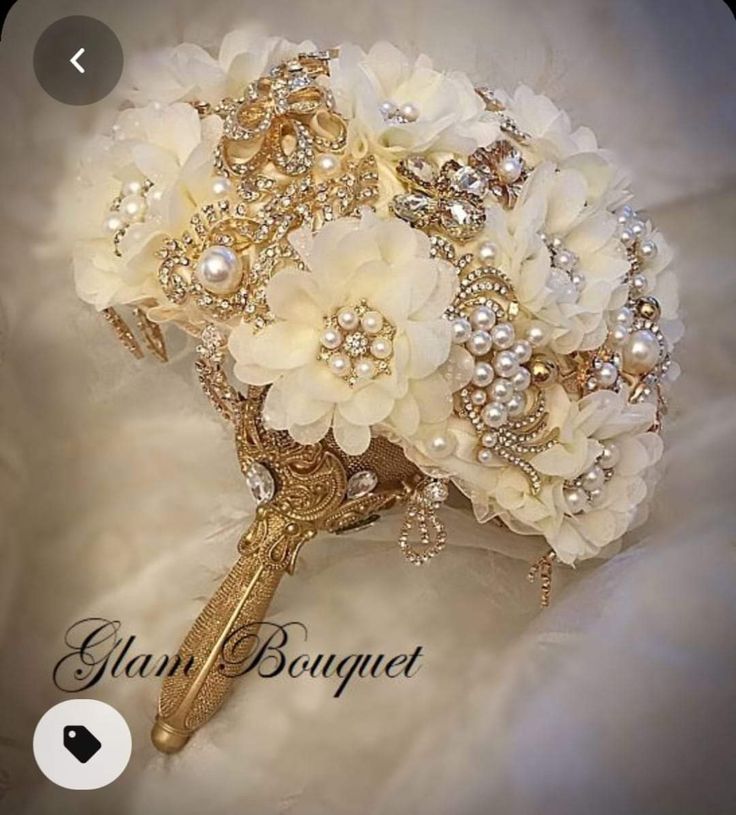 a bridal bouquet with white flowers and pearls