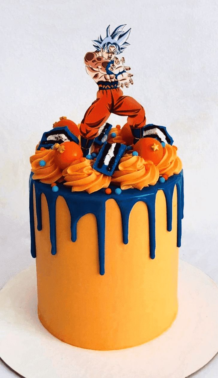 a birthday cake decorated with an image of gohan on top and orange icing