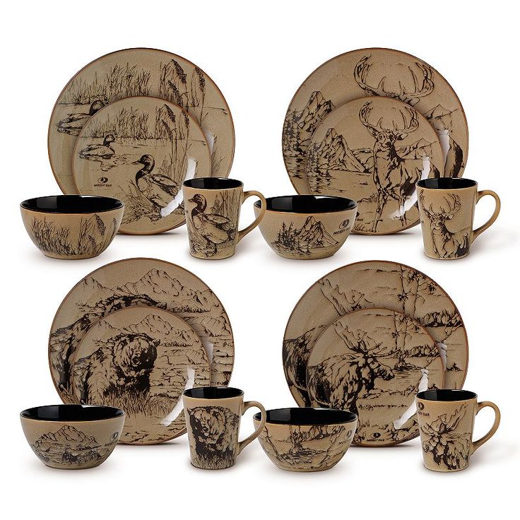 a set of dinnerware with black and white designs