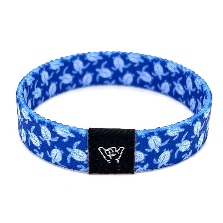 Show your love for the ocean's cutest sea creature with this vibrant blue sea turtle bracelet. Available sizes:  Extra Small 5.5" (petites + kids) Small 6.5" (most common fitting size) Medium 7.5" (large wrists) Large or Anklet 8.5" (very large wrists or anklet) 1/2" Width Reversible surf and beachy prints. Elastic blend material, can stretch to desired fit. Packaged in natural drawstring gift pouches. Machine washable. Chlorine and saltwater safe. Hang Loose Bracelet, Coastal Bracelet, Beachy Prints, Surf Music, Sea Turtle Bracelet, Beach Bracelet, Turtle Bracelet, Beach Bracelets, Friendship Jewelry