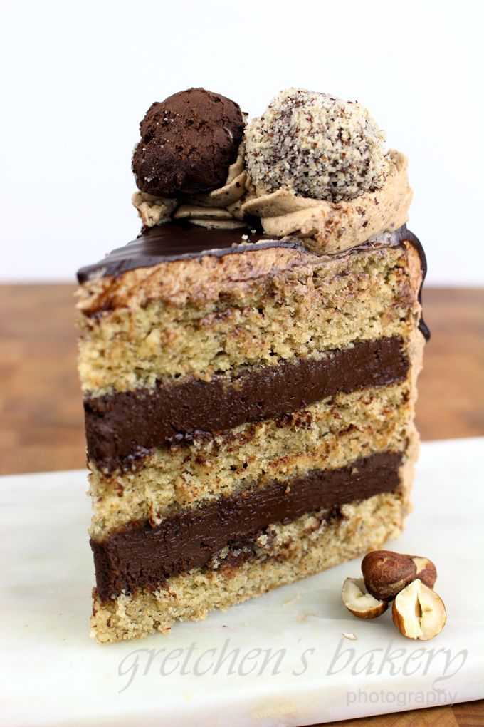 there is a piece of cake with chocolate and nuts on top