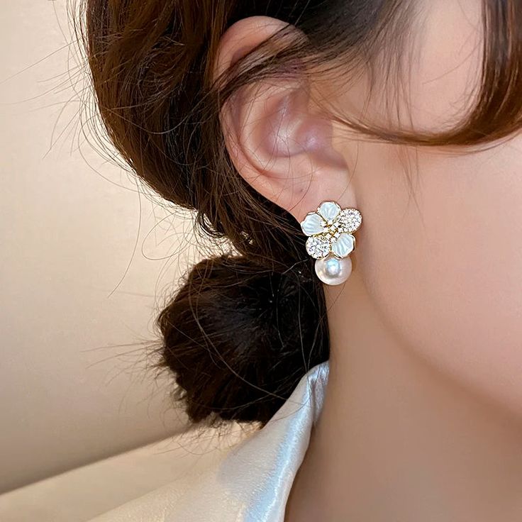 The Ryann Earrings exude luxury and elegance with their French design and sparkling micro set zircon stones. The white enamel camellia pearl pendant adds a touch of sophistication and fashion-forward style. A must-have accessory for any woman looking to make a statement. Pearl Pendant Earrings, Plant Pattern, Enamel Flower, Fashion Accessories Jewelry, Pearl Drop Earrings, Elegant Earrings, French Design, Pearl Drop, White Enamel