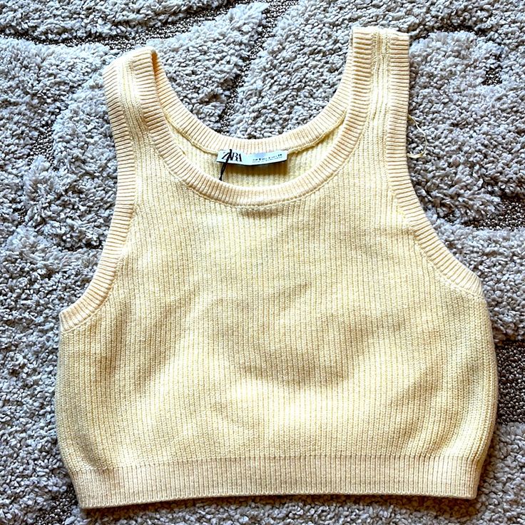 **Viscose/Polyester/Nylon/Elastane Knit Cropped Sleeveless Sweater **Lemon Yellow **15.5 Inches Pit To Pit **13 Inches Center Back ** Brand New With Tags ** Smoke Free Home Casual Beige Crop Top Vest, Casual Beige Vest Crop Top, Yellow Ribbed Sleeveless Tank Top, Fitted Knit Vest For Day Out, Seamless Knit Sweater Vest For Spring, Spring Seamless Knit Sweater Vest, Spring Knit Sweater Vest Seamless, Sleeveless Knit Top For Beach In Fall, Chic Sleeveless Knitted Crop Top