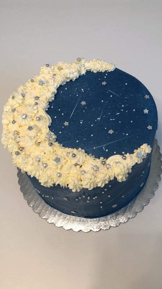 a blue cake with white frosting and stars on it