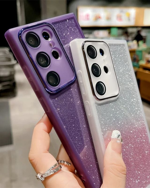 two purple and white cases are held up in the air by someone's hand