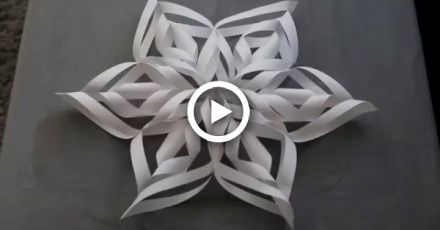 an origami snowflake made out of white paper