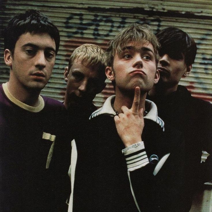 four young men standing next to each other