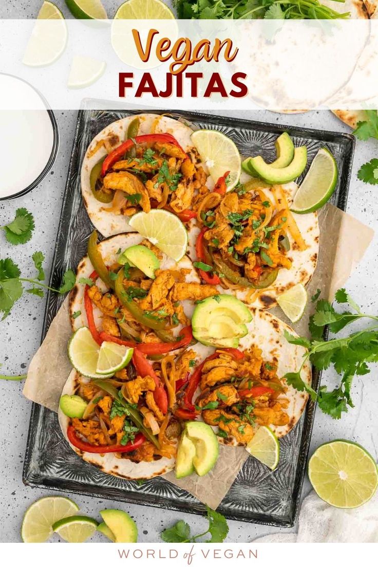 an image of chicken fajitas on a tray with limes and cilantro