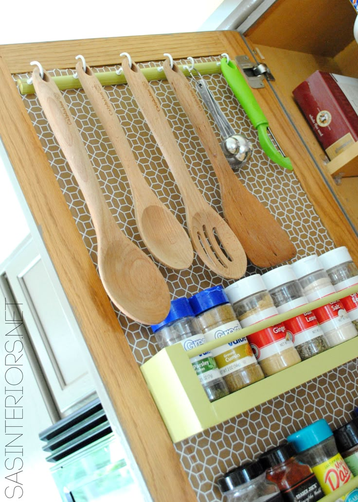 a wooden spoons and utensils are organized in a drawer