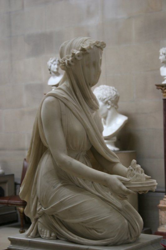 a statue of a woman holding a bowl