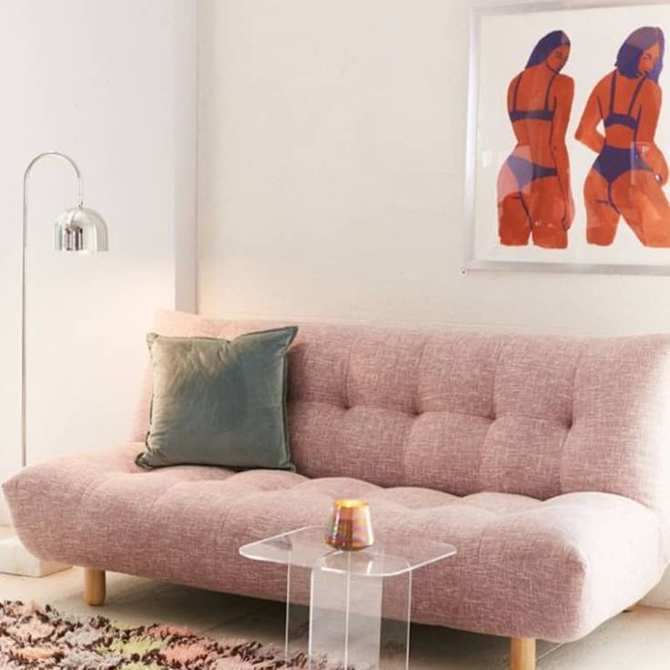 a living room with a pink couch and rug